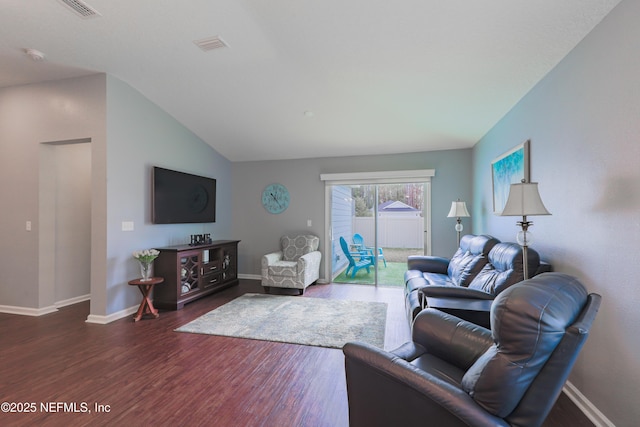 living room featuring dark hardwood / wood-style flooring and vaulted ceiling