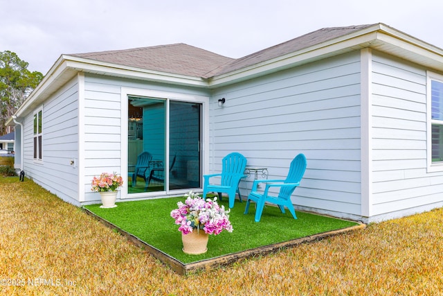 rear view of house with a yard