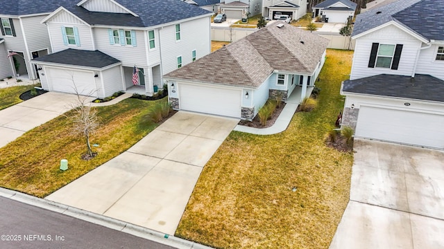 view of front of property featuring a garage and a front lawn