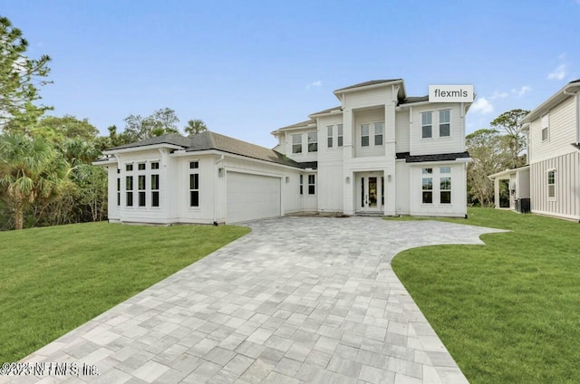 view of front facade featuring a garage and a front yard