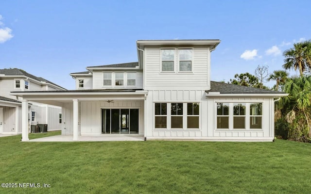 rear view of house with ceiling fan, a yard, and a patio