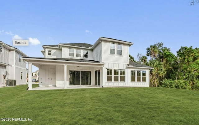 rear view of house with a lawn and a patio