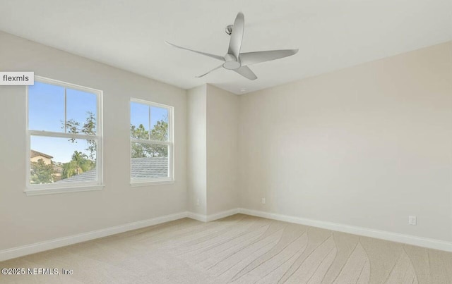 carpeted spare room with ceiling fan