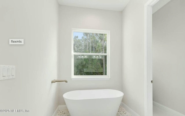 bathroom with a tub to relax in