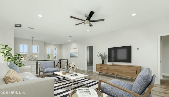 living room featuring light hardwood / wood-style floors and ceiling fan