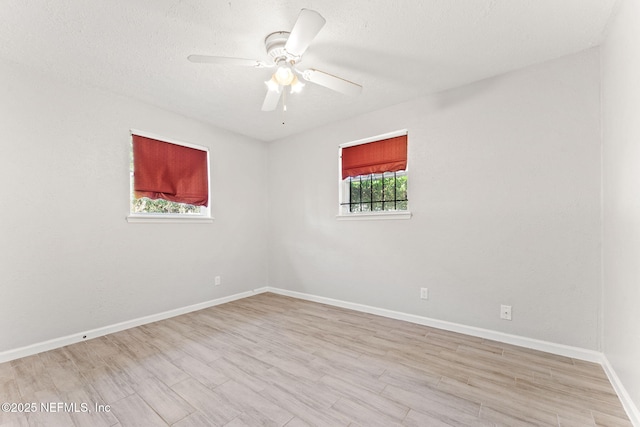 unfurnished room with a textured ceiling, light hardwood / wood-style flooring, and ceiling fan