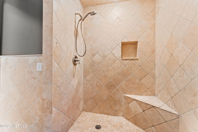 bathroom featuring tiled shower