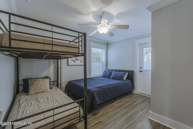 bedroom with crown molding, ceiling fan, and a textured ceiling