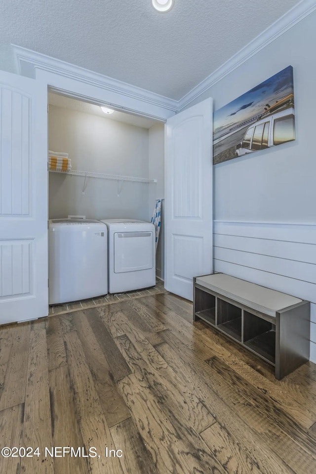 laundry area featuring separate washer and dryer, crown molding, wood-type flooring, and a textured ceiling