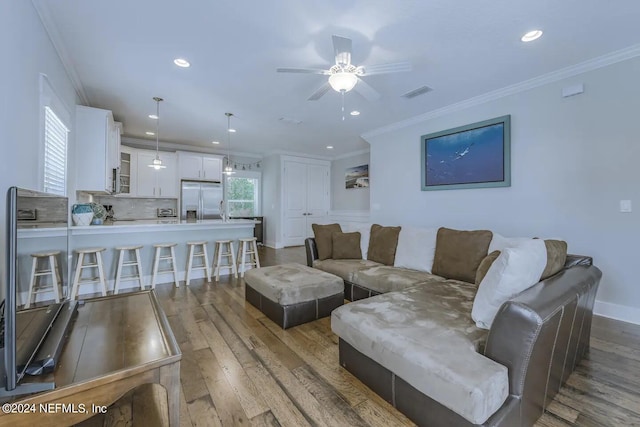 living room with crown molding and wood-type flooring