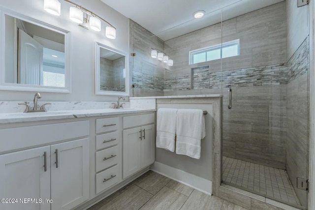 bathroom featuring vanity and an enclosed shower