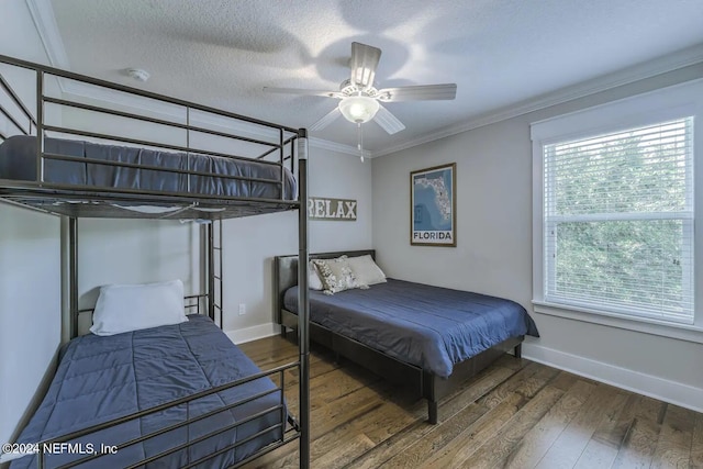 bedroom featuring ceiling fan, crown molding, dark hardwood / wood-style floors, and a textured ceiling