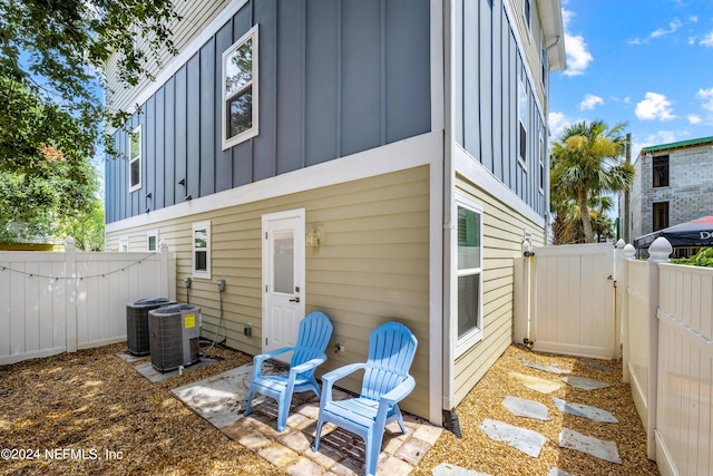 back of property featuring central air condition unit