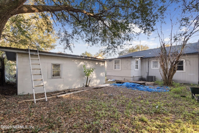 rear view of property with central AC unit