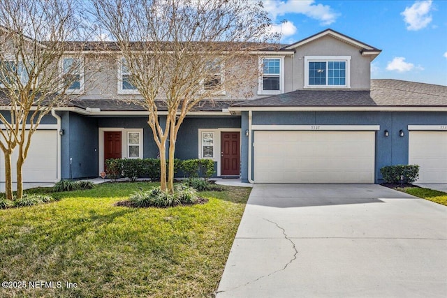 view of front of house featuring a garage and a front lawn