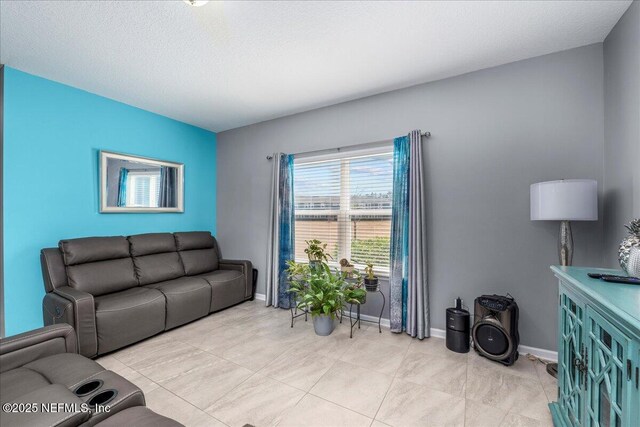 living room featuring light tile patterned flooring and a textured ceiling