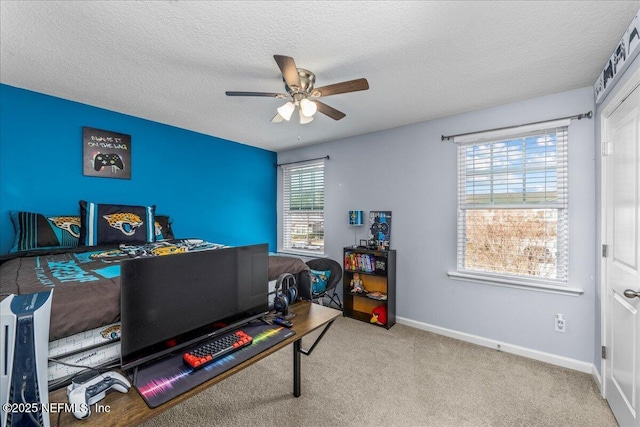 office space with ceiling fan, light colored carpet, and a textured ceiling