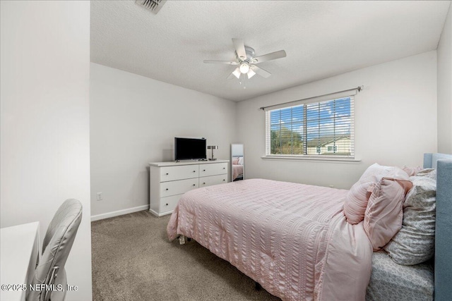 carpeted bedroom featuring ceiling fan and a textured ceiling