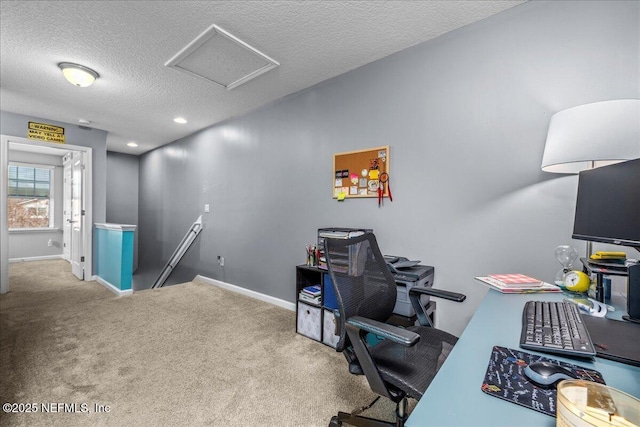 office with carpet floors and a textured ceiling