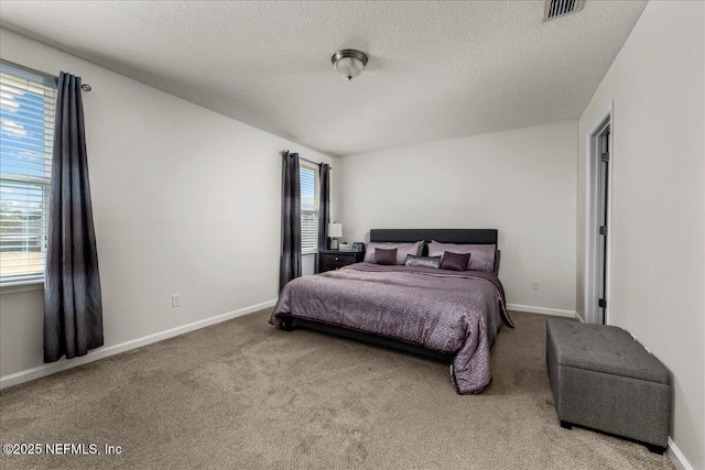 carpeted bedroom featuring a textured ceiling