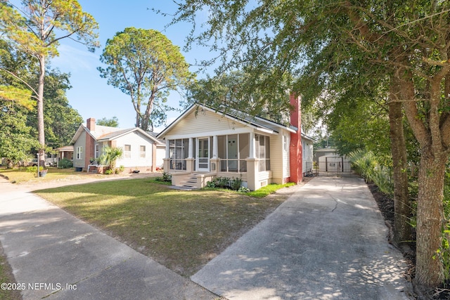 bungalow featuring a sunroom and a front yard