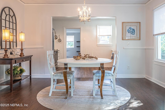 dining room featuring dark hardwood / wood-style flooring, ornamental molding, and a chandelier