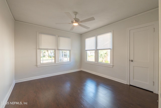 empty room featuring ceiling fan, ornamental molding, and dark hardwood / wood-style flooring