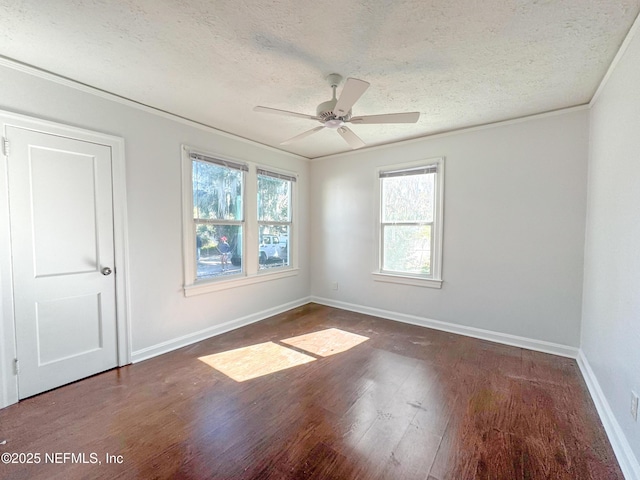 spare room with ceiling fan, crown molding, dark hardwood / wood-style floors, and a textured ceiling