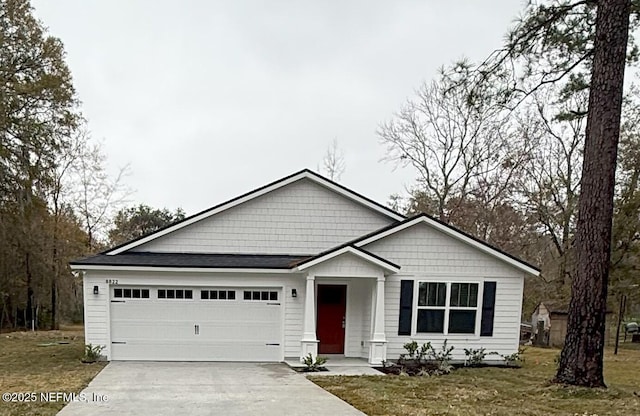 view of front of property with a garage and a front yard