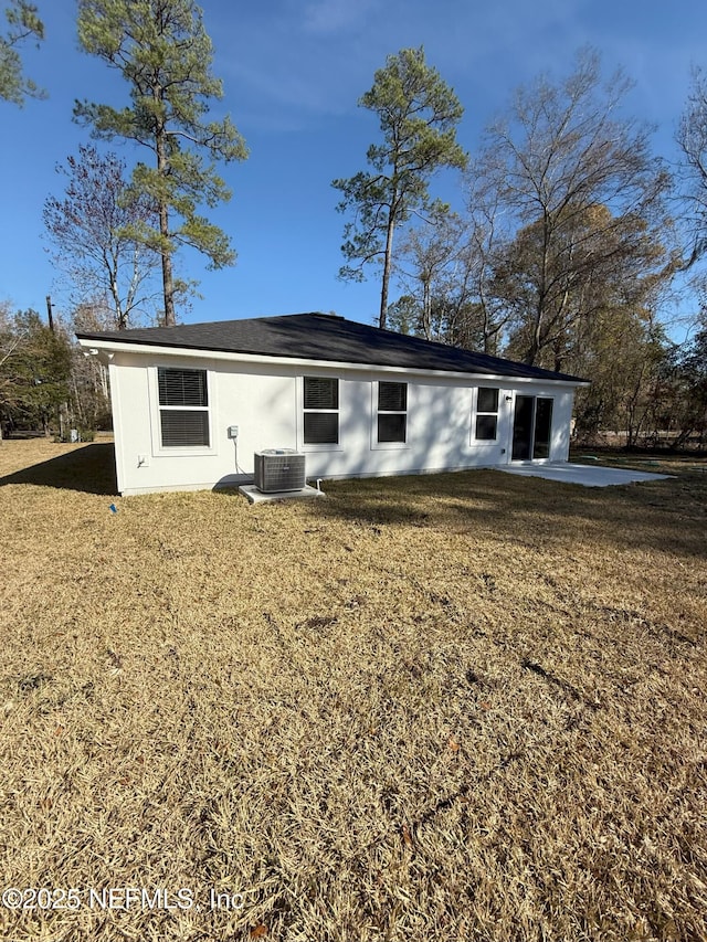 back of property featuring a yard, a patio area, and central air condition unit