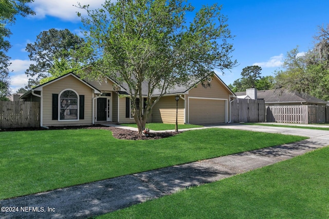 single story home with a garage and a front lawn