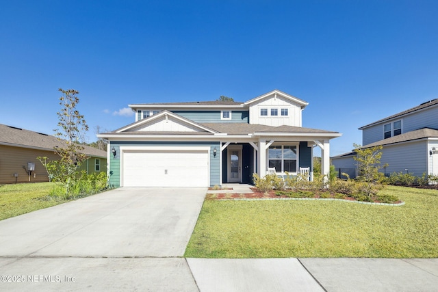 view of front of property featuring a garage, a front yard, and covered porch