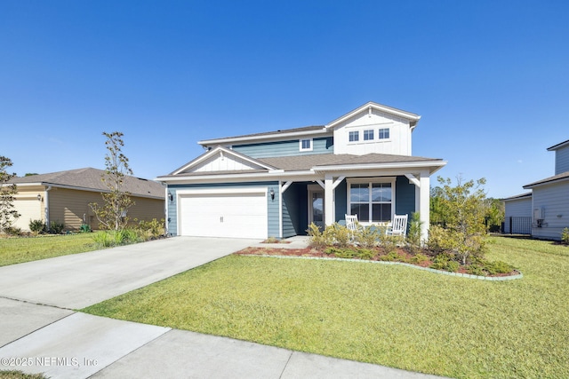 view of front of property featuring a garage, a front lawn, and covered porch