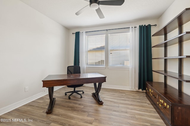 office with ceiling fan and light wood-type flooring