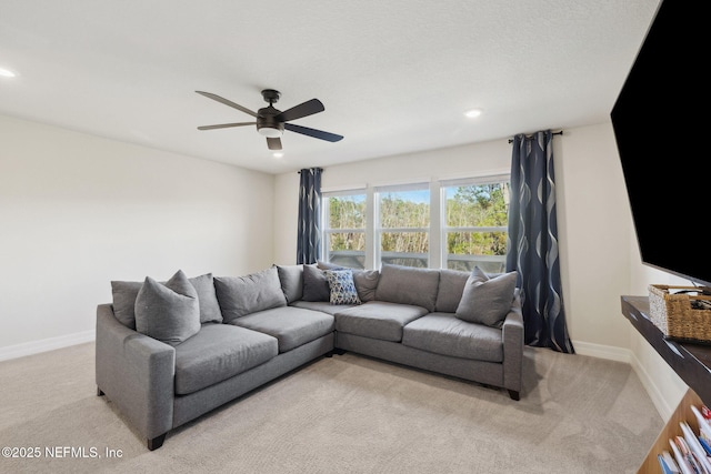 carpeted living room featuring ceiling fan