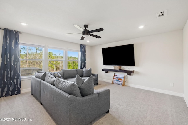 living room featuring light carpet and ceiling fan