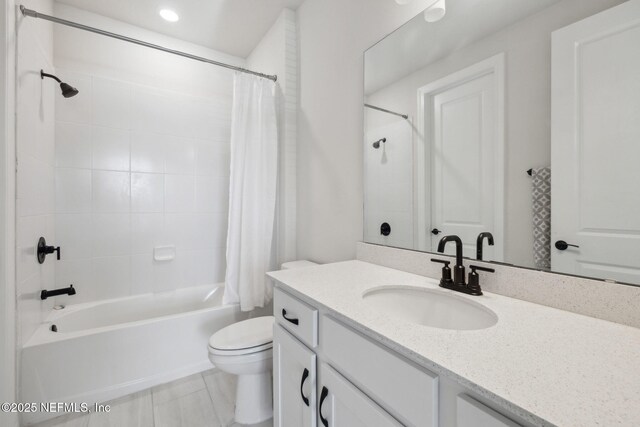 full bathroom featuring vanity, toilet, and shower / tub combo with curtain