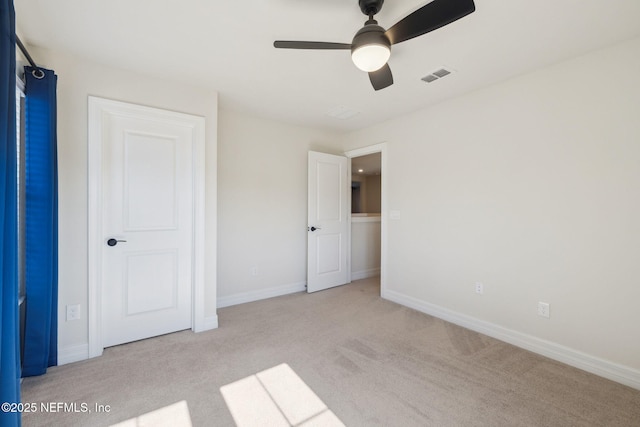 unfurnished bedroom featuring ceiling fan and light carpet