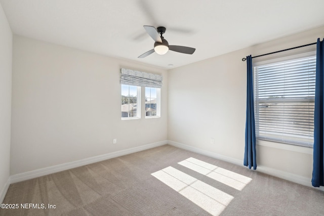 carpeted spare room with ceiling fan