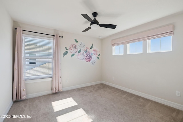 carpeted spare room with ceiling fan