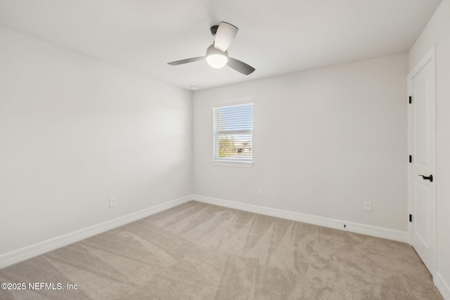 empty room featuring light colored carpet and ceiling fan