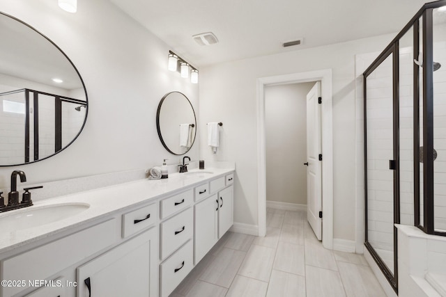 bathroom featuring an enclosed shower and vanity