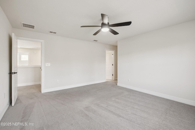 carpeted spare room with ceiling fan