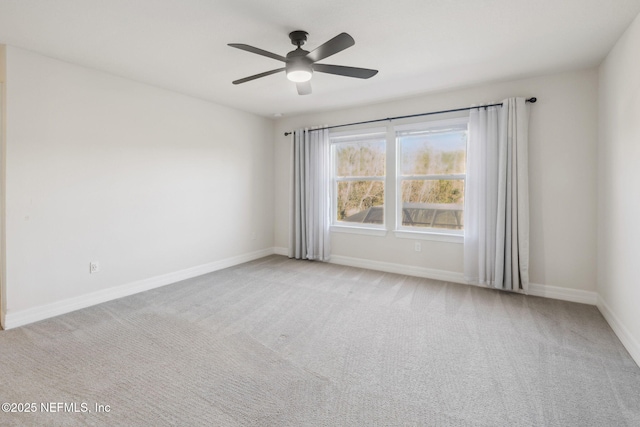 empty room featuring light carpet and ceiling fan