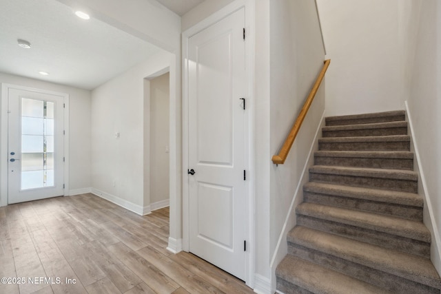 stairs featuring wood-type flooring