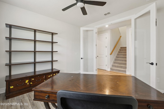 office with ceiling fan and light hardwood / wood-style flooring