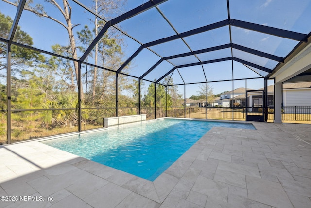 view of swimming pool with glass enclosure and a patio area