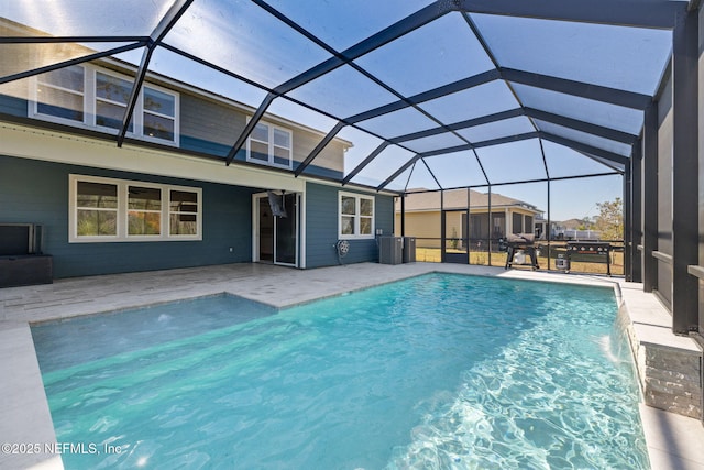 view of pool featuring pool water feature, a patio area, and glass enclosure