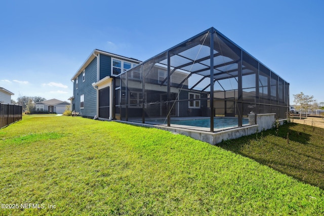 back of property with a yard and a lanai