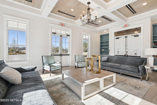 living room featuring wood-type flooring, coffered ceiling, and beam ceiling